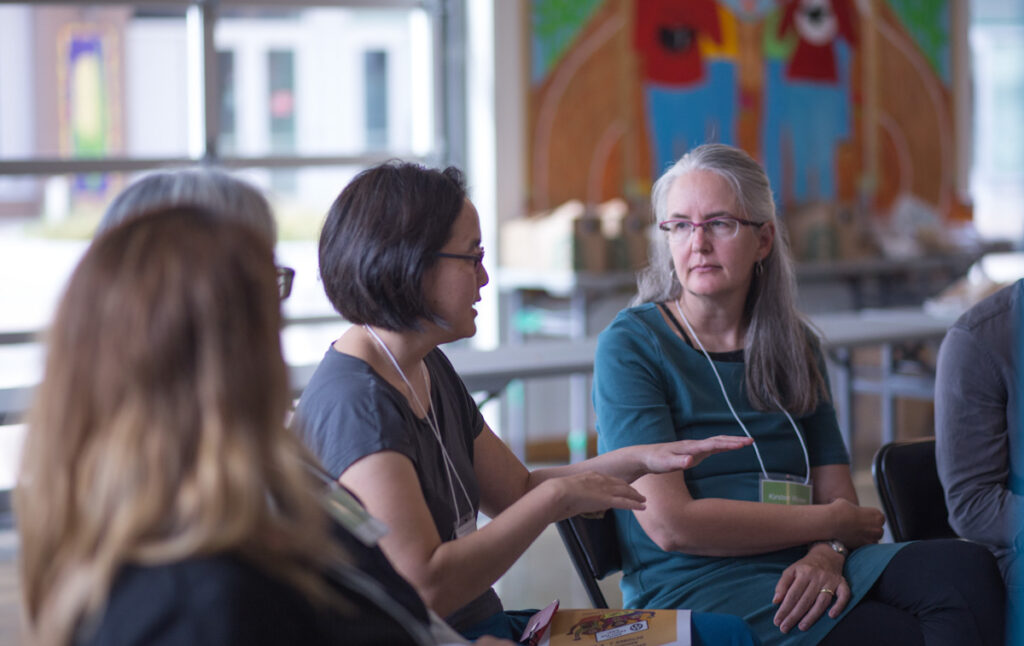 Small group of women, seated, in conversation with another individuals out of the frame / photo courtesy of King County