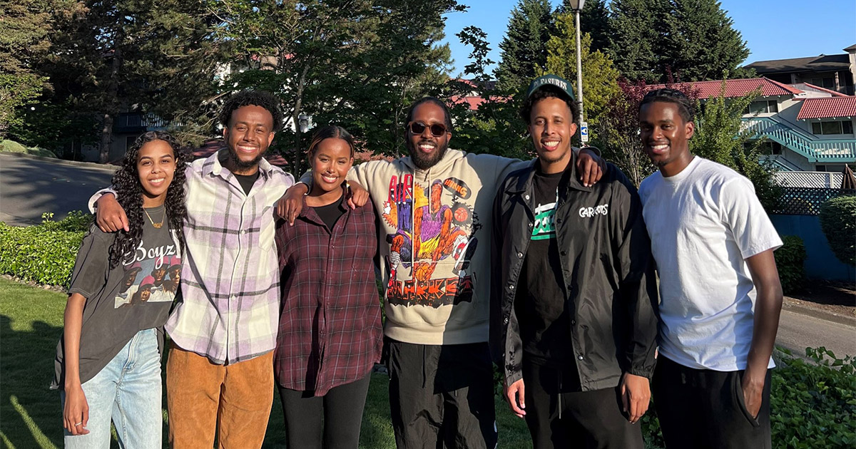 Group of Got Your Back members standing outside on a sunny day. Got Your Back engages youth through sports and arts to build a community that can foster wellness.