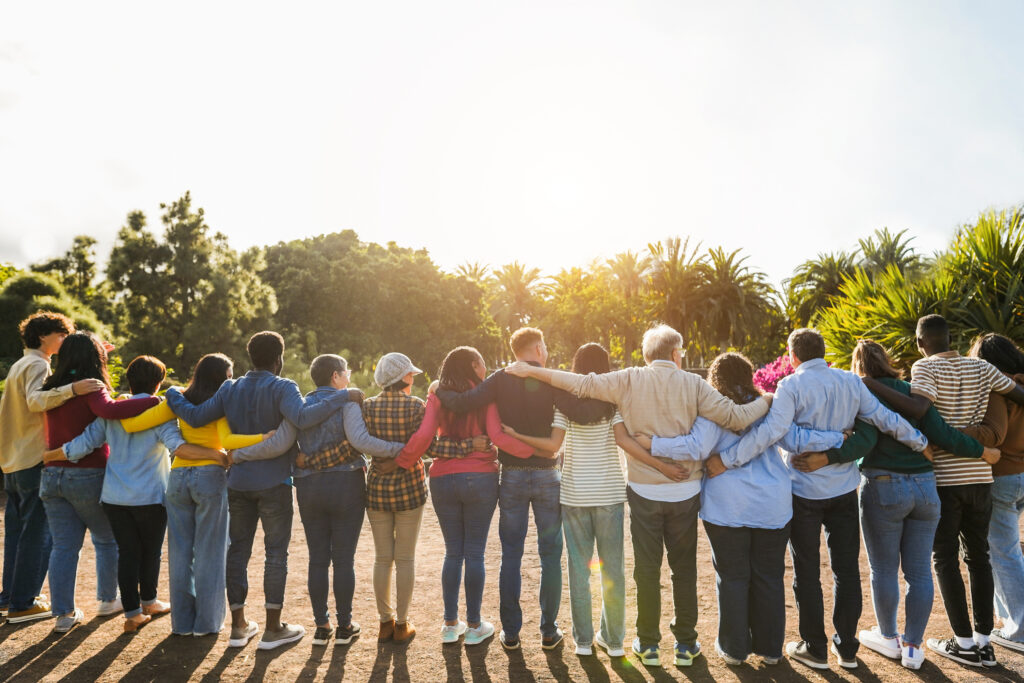 A group of people standing hand in hand symbolizing togetherness