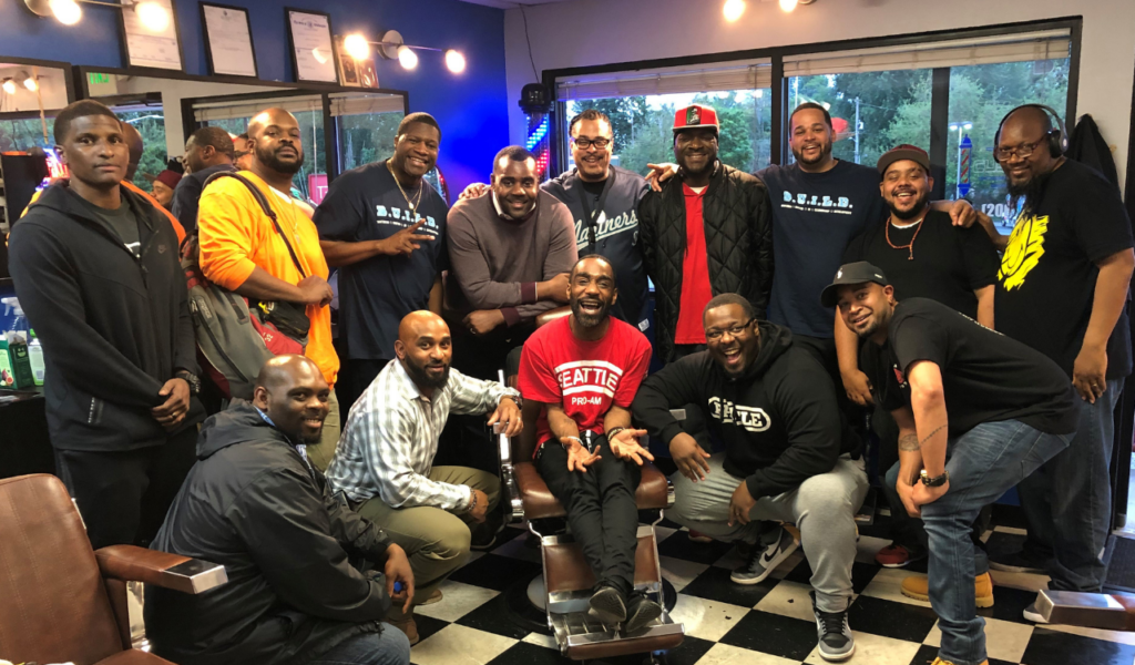 Members of Brothers United in Leadership Development (BUILD) after their BUILD Barbershop Series event at Paul’s Customs Cuts in 2019. Photo credit: Darryl Glover / Dancing in the Rain Media
